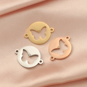 Polished hollow butterfly connectors in gold silver and rose gold on pink silk
