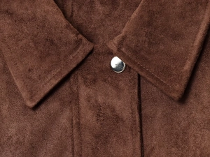 Close-up of brown faux suede jacket collar with polished silver metal buttons