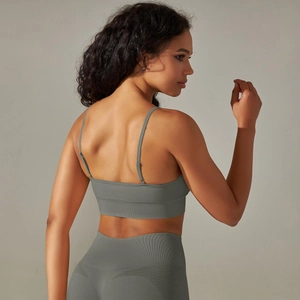 Detail of cross-back straps on seamless olive yoga bra and moisture-wicking fabric texture