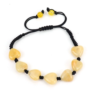 Detail of handmade woven black cord bracelet featuring seven heart-shaped yellow agate stones