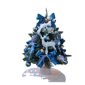 Mini DIY Christmas tree with blue bows and reindeer figurines on a wooden base