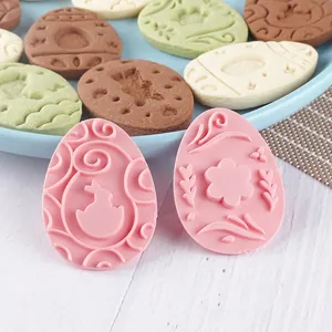 Easter egg-shaped cookie molds set featuring rabbit and floral patterns for DIY baking