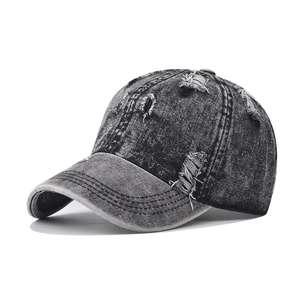 Distressed vintage washed denim baseball cap with frayed holes and acid wash gray finish
