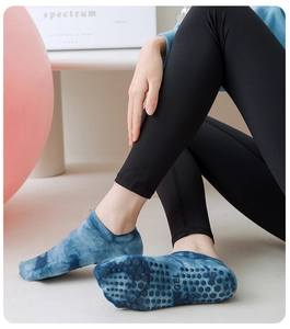 Close-up of blue tie-dye yoga socks with hexagonal silicone non-slip grip on the sole