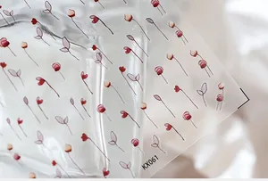 Detailed macro view of KX061 floral nail art stickers with delicate red flower patterns