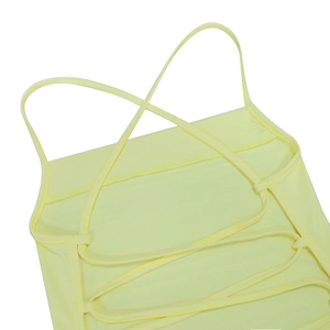 Detail of cross-straps on the back of a pale yellow sexy backless maxi dress