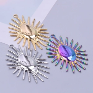 Three sun-patterned oval metal pendants in gold, silver, and rainbow electroplated finish