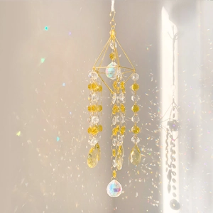 Detail of K9 crystal sun catcher showing rainbow reflections from clear prism balls