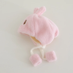 Pink plush baby winter hat with cute rabbit ears and decorative pompom straps detail