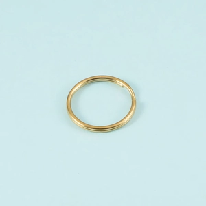 Detail of a golden stainless steel split key ring with a smooth polished metal finish
