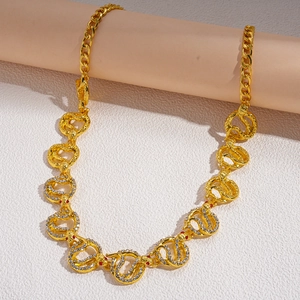 Detailed view of the gold-toned snake-shaped chain links with sparkling rhinestones