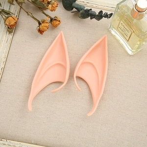Detail view of skin-colored silicone elf ears for cosplay and Halloween on linen background
