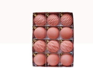 Detail of twelve pink Christmas balls with smooth and spiral textures in a clear set