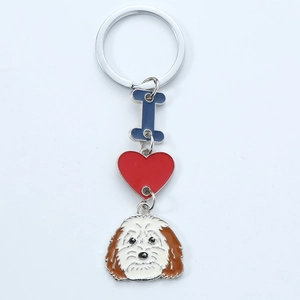 Detail of enamel dog, heart and bone pendants on a silver metal keychain ring