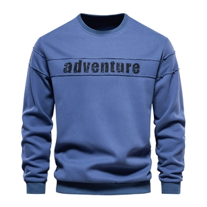 Detail of gray-blue sweatshirt featuring ribbed crew neck and vintage adventure print