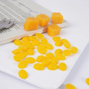 Miniature resin mango cubes and raspberry fruit models for DIY crafts on a ceramic tray