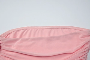 Detail of pink off-shoulder top showing internal silicone anti-slip strip for secure fit