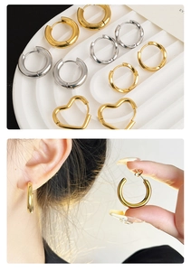 Detail of vintage bamboo style hoop earrings and heart studs in gold and silver finish