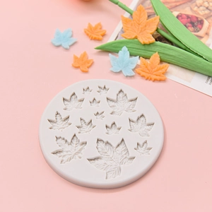 Silicone maple leaf mold for fondant and chocolate cake decorations on pink background