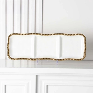 Close-up of white ceramic 3-compartment tray with golden beaded edge on a display stand
