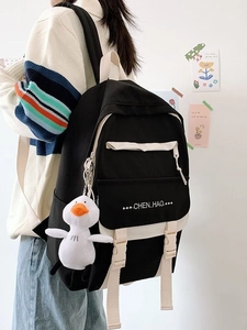 Black high-capacity school backpack with cute duck pendant and campus style design