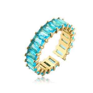 Detailed close-up of blue rectangular zircon on a gold-plated open ring band