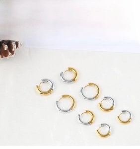 Macro display of assorted size gold and silver two-tone stainless steel hoop earrings