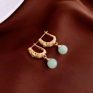 Vintage Chinese style gold earrings with carved flower motifs and green stone beads