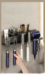 Grey wall-mounted bathroom rack with hairdryer holder and electric toothbrush storage slots