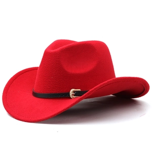 Close-up of bright red felt cowboy hat with black leather band and gold floral buckle