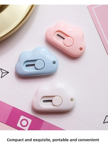 Close-up of portable cloud-shaped mini utility knives in pink, blue and white colors