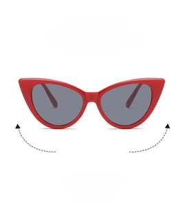 Detail view of red cat-eye sunglasses with dark grey lenses and polished retro frame
