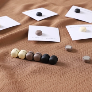 Detailed view of matte magnetic hijab pins in beige, brown, and black colors