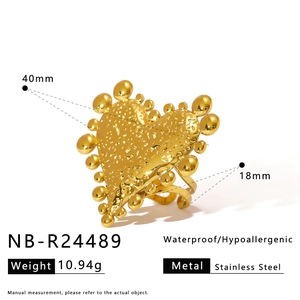 Detailed view of gold stainless steel heart ring with starfish inlay and hammered texture