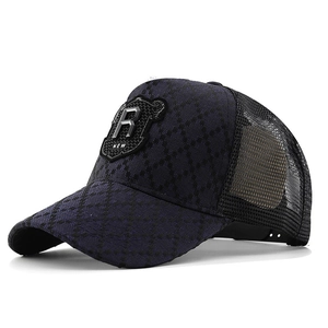Dark blue trucker hat with quilted diamond pattern and a metal R patch on the front