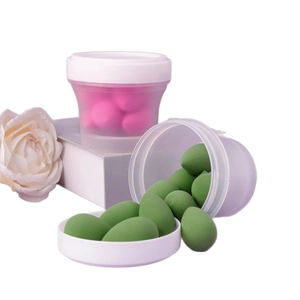 Mini teardrop makeup sponges set in translucent storage jars with floral decor