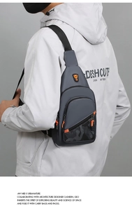 Detail view of stylish men's gray chest bag with bright orange zippers and camo print
