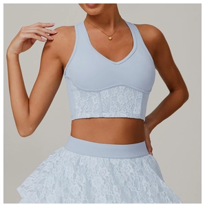 Detail shot of light blue lace crop top with V-neckline and intricate floral mesh textures