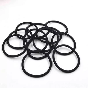 Set of 12 black elastic hair ties and simple rubber bands on a plain white background