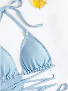 Detail eines hellblauen Halter-Bikinioberteils mit geraffter Textur und SHEIN-Etikett