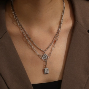 Detail view of silver double-layered necklace with North Star pendants on a model
