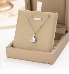 Macro shot of silver six-prong necklace with round-cut sparkling cubic zirconia