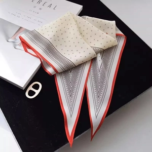 Silk-like long scarf with black star patterns, orange borders and geometric V-ends