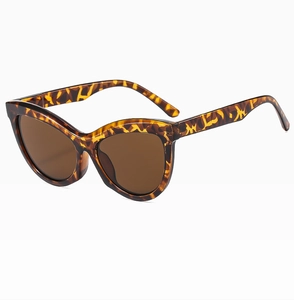 Detail view of tortoiseshell cat eye sunglasses with brown lenses from a 45-degree angle