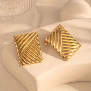 Irregular geometric square earrings in gold finish with textured metal relief
