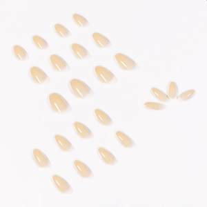 Glossy milky nude short ballerina press-on nails with semi-transparent finish on white