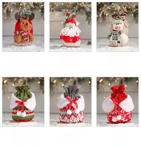 Detail of Christmas drawstring gift bags featuring 3D Santa, elk, and snowman designs