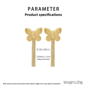 Detailed view of golden butterfly earrings with long metal tassel in stainless steel