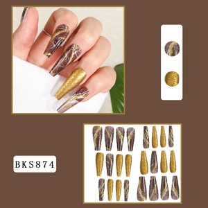 Macro detail of 24 long coffin fake nails in brown marble and gold glitter design