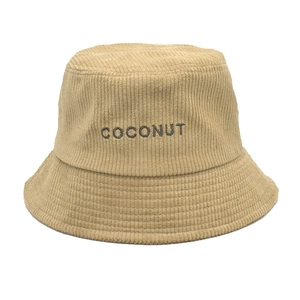 Close-up of beige corduroy bucket hat with COCONUT embroidery and ribbed texture